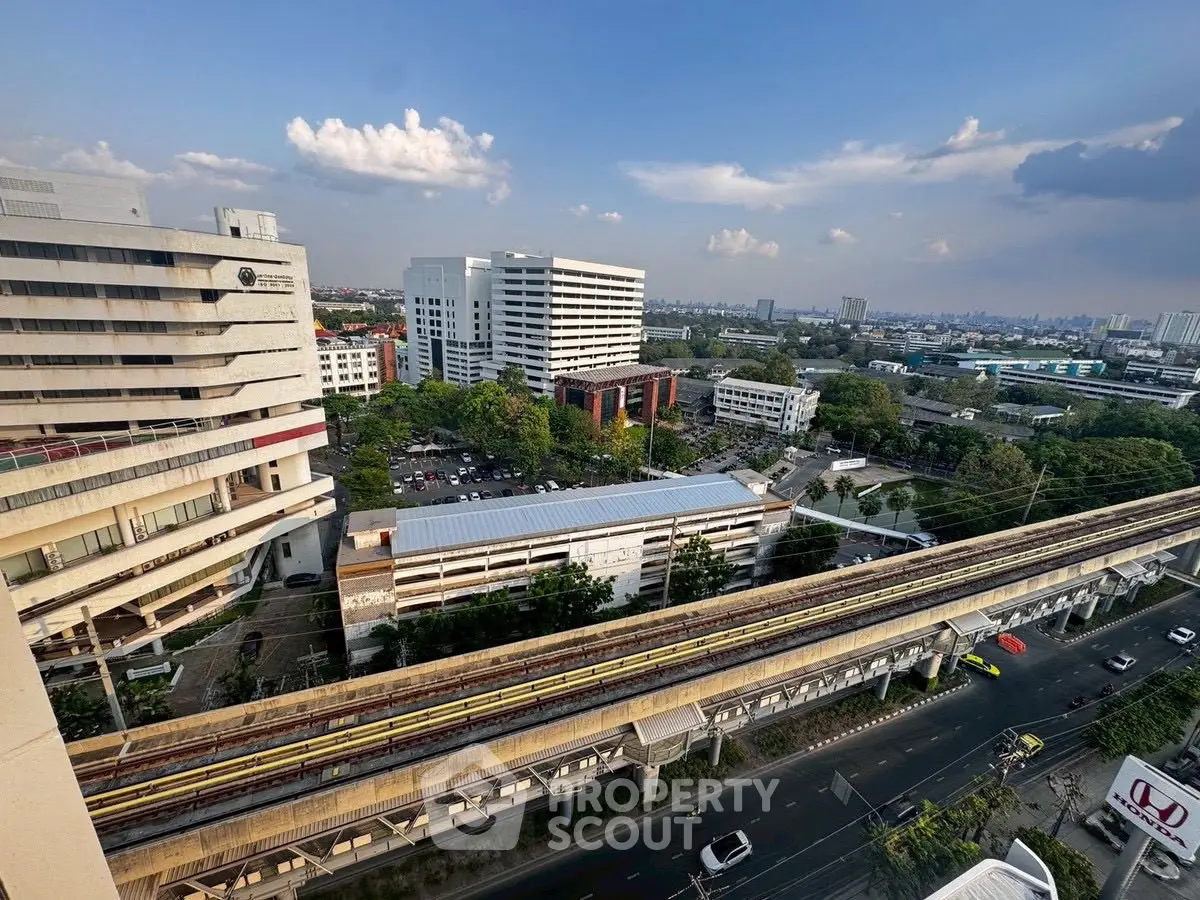 Stunning cityscape view from high-rise building with clear skies and urban infrastructure.