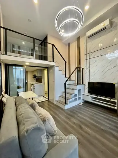 Modern loft-style living room with high ceilings and elegant lighting in a chic apartment.