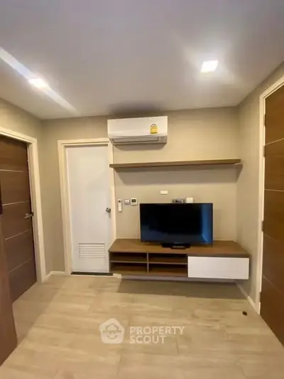 Modern living room with mounted TV and air conditioning unit