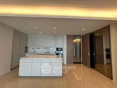 Luxurious modern kitchen with sleek cabinetry and island in upscale apartment