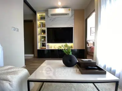 Modern living room with stylish decor and built-in TV unit, showcasing a cozy and inviting atmosphere.