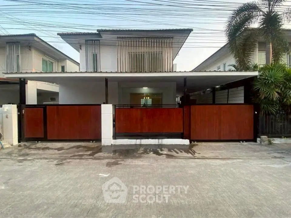 Modern two-story house with gated entrance and spacious driveway