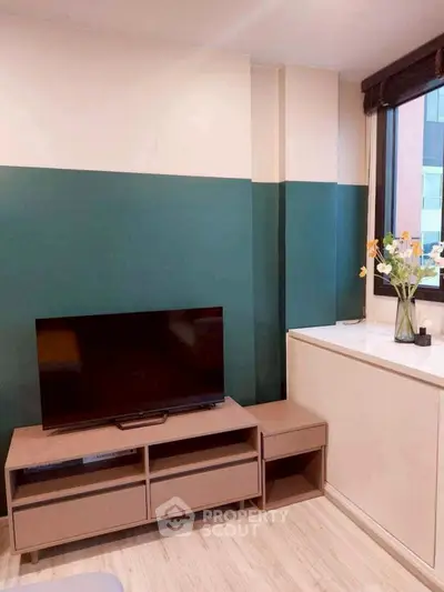 Modern living room with stylish TV stand and large window view