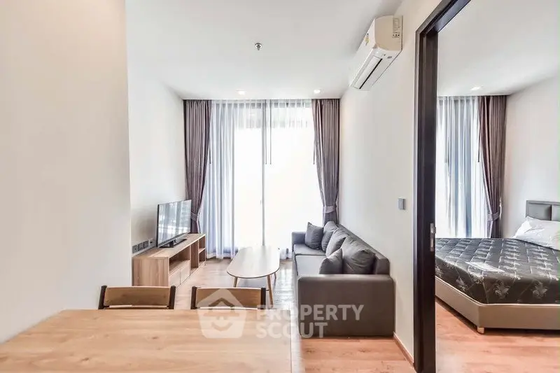 Modern apartment interior with cozy living room and bedroom, featuring stylish furniture and natural light.