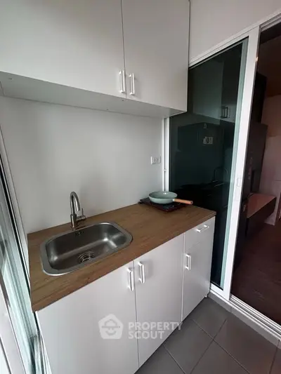 Modern compact kitchen with sleek cabinetry and stainless steel sink