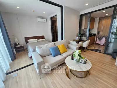 Modern open-plan living room with cozy sofa and elegant decor