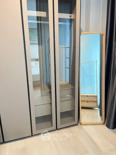 Modern bedroom with sleek wardrobe and stylish floor mirror