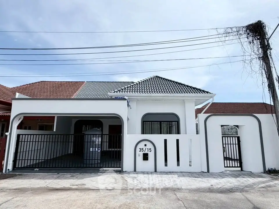 Charming single-story home with modern facade and gated entrance in a serene neighborhood.
