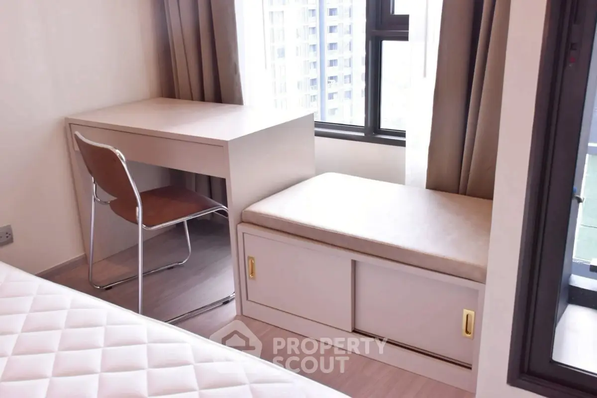 Modern study area with desk and window seating in bright apartment