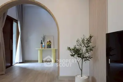 Elegant modern interior with archway, stylish decor, and natural light.
