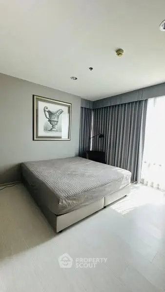 Spacious bedroom with modern decor and natural light