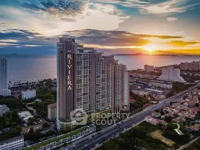 Stunning high-rise building with ocean view at sunset, perfect for luxury living.