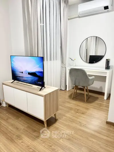 Modern living room with sleek TV stand, stylish desk, and elegant decor