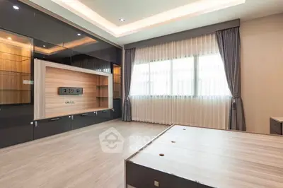 Spacious modern bedroom with sleek built-in storage and large window
