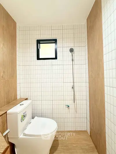 Modern bathroom with sleek design and high-quality fixtures, featuring a stylish shower and elegant tile work.