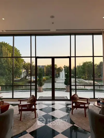 Luxurious living room with stunning garden view through floor-to-ceiling windows.