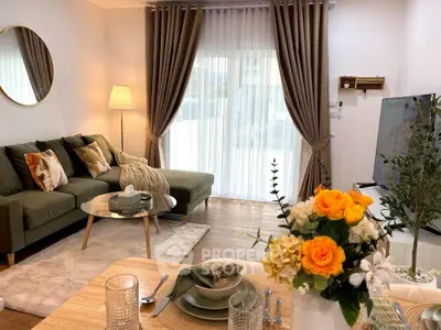 Stylish living room with modern decor, cozy seating, and elegant dining setup, perfect for relaxation and entertaining.
