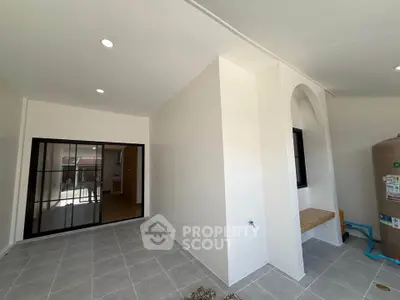 Modern interior space with tiled flooring and arched window, ideal for versatile use.