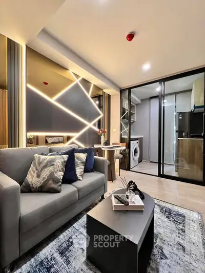 Modern living room with stylish decor and open kitchen layout in a chic apartment.