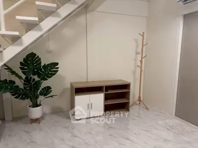 Modern interior with sleek staircase and minimalist furniture in a stylish living space.