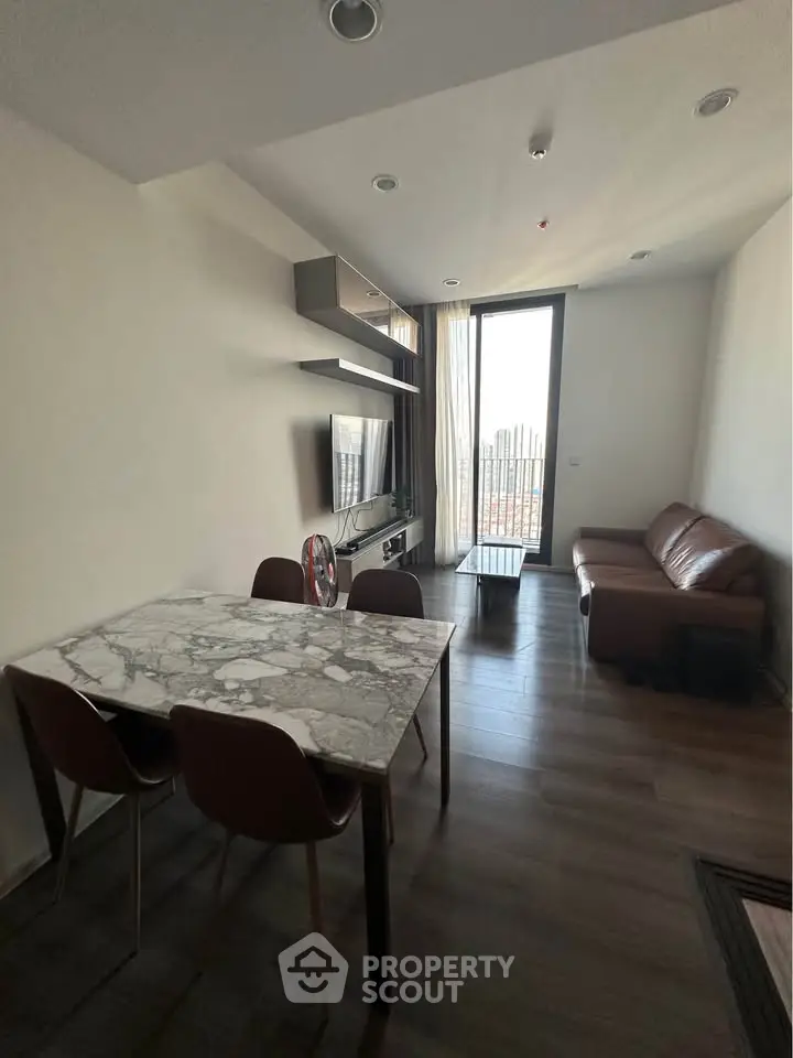 Modern living room with marble dining table and cozy seating area