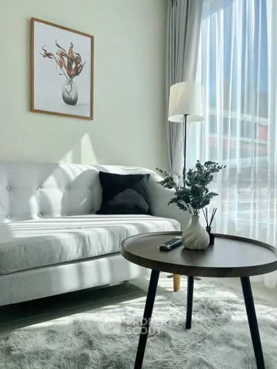 Stylish living room with modern decor, cozy sofa, and natural light