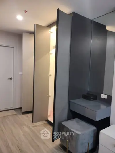 Modern bedroom with sleek wardrobe and stylish vanity area