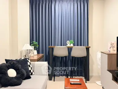 Cozy modern living room with stylish decor and bar seating by the window.