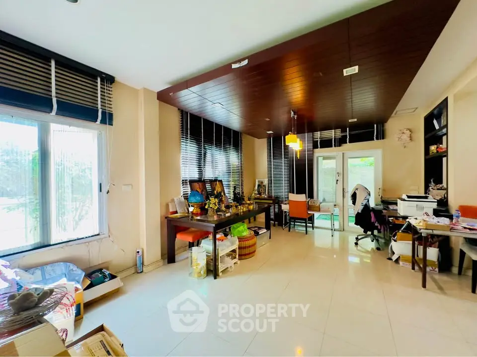 Spacious and bright living room with modern decor and large windows