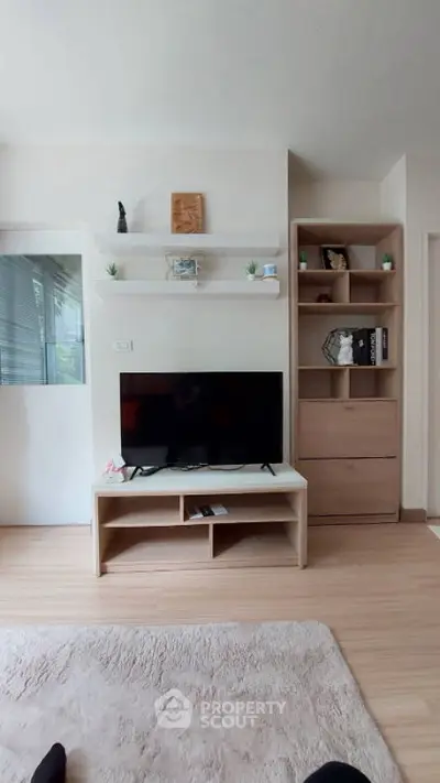 Modern living room with sleek TV stand and stylish shelving, perfect for contemporary urban living.