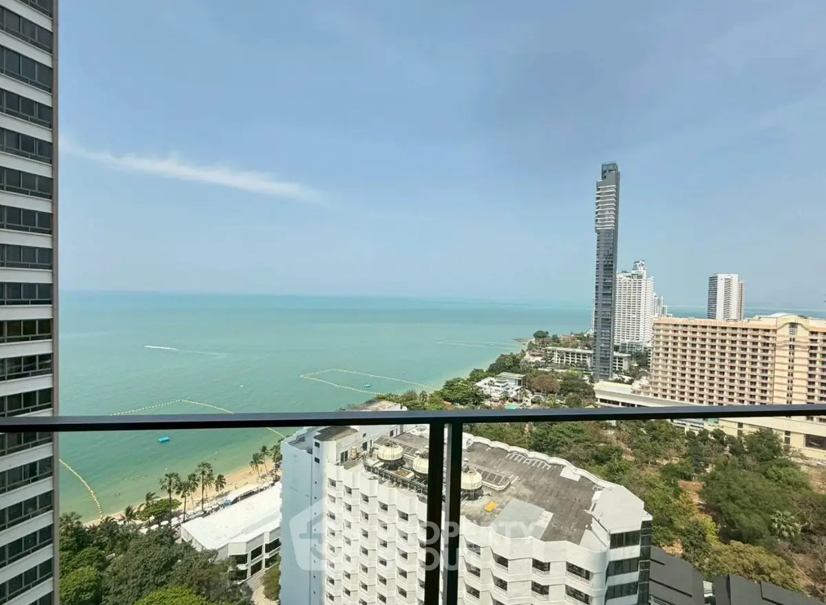 Stunning ocean view from high-rise balcony overlooking cityscape and coastline.