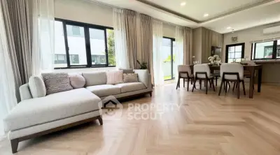 Spacious modern living room with elegant dining area and large windows