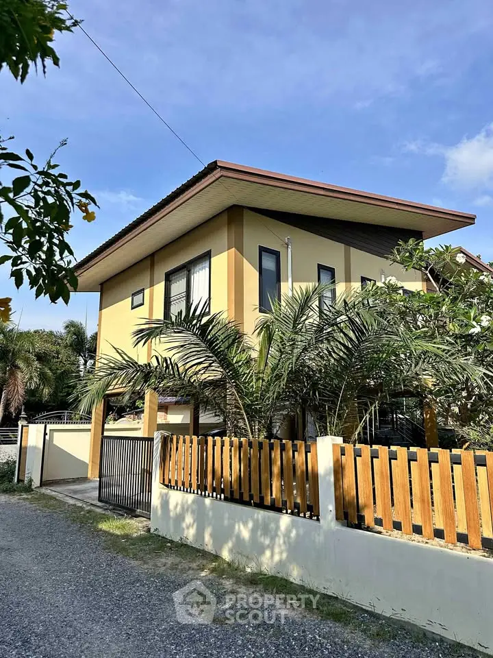 Charming two-story house with modern design and lush garden in serene neighborhood.