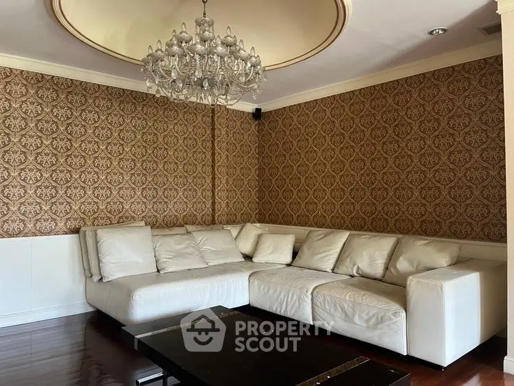 Elegant living room with luxurious chandelier and stylish wallpaper