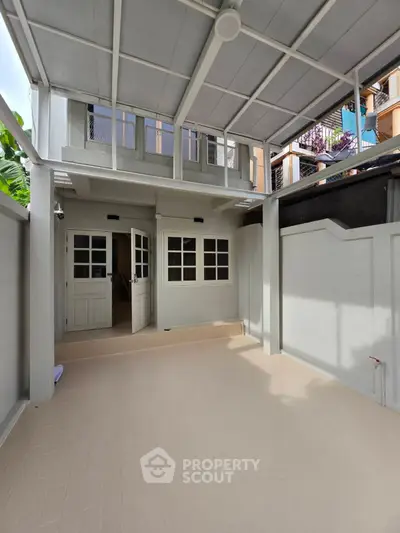 Spacious covered patio area with modern design and ample natural light