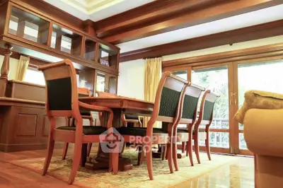 Elegant dining room with wooden furniture and large windows