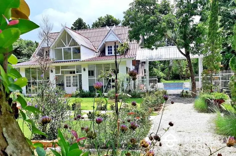 Charming countryside house with lush garden and inviting entrance