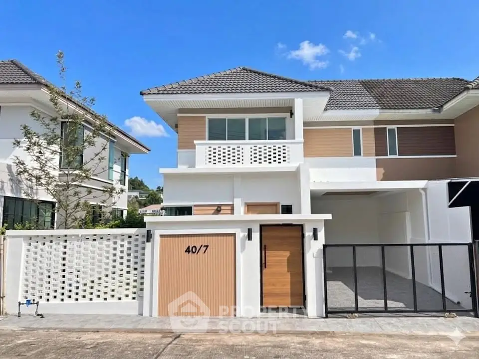 Modern two-story house with a sleek design and spacious driveway in a serene neighborhood.