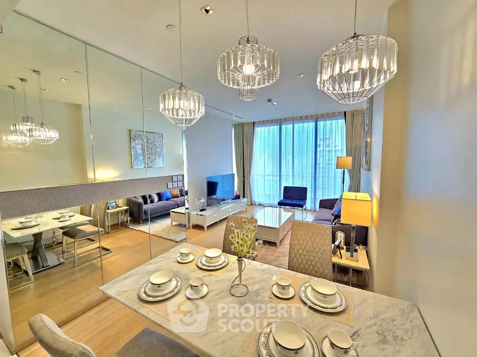 Luxurious modern living room with elegant dining area and stylish lighting fixtures.