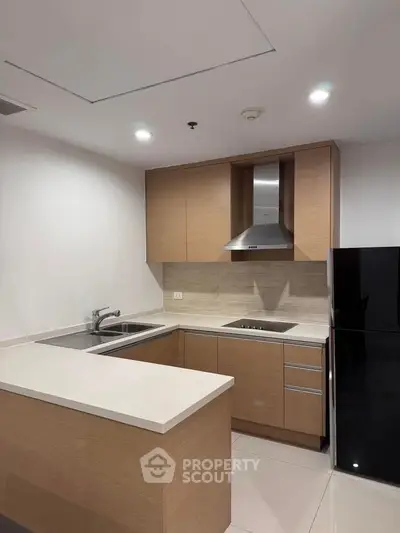Modern kitchen with sleek cabinetry and built-in appliances in a contemporary apartment.