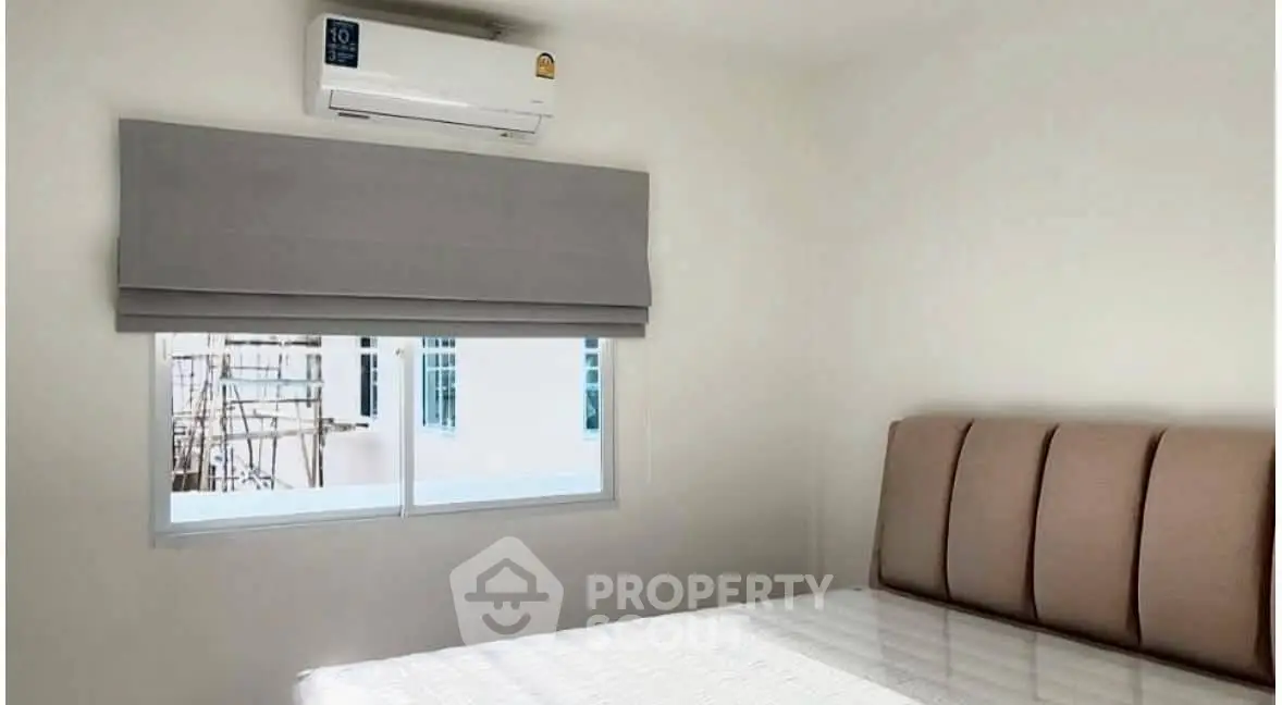 Cozy bedroom with air conditioning and natural light, perfect for relaxation.