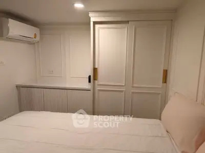 Cozy bedroom with built-in wardrobe and air conditioning, perfect for a comfortable living experience.