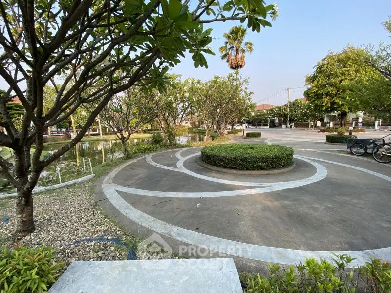 Beautiful garden area with circular pathways and lush greenery in a serene neighborhood.