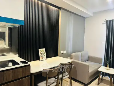 Modern living room with sleek design, featuring a cozy sofa, dining table, and stylish wall paneling.