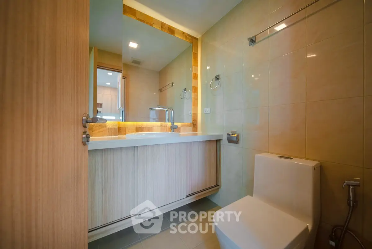 Modern bathroom with sleek fixtures and warm lighting