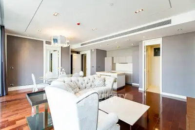 Luxurious open-plan living room with elegant furniture and modern kitchen