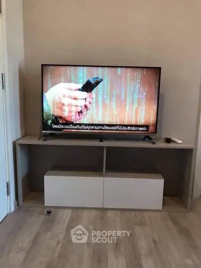 Modern living room with sleek TV stand and flat-screen television.