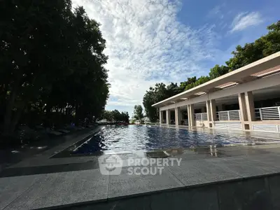 Luxurious outdoor pool area with modern design and lush greenery