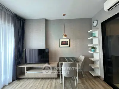 Modern living room with stylish decor, featuring a TV, dining table, and elegant shelving.