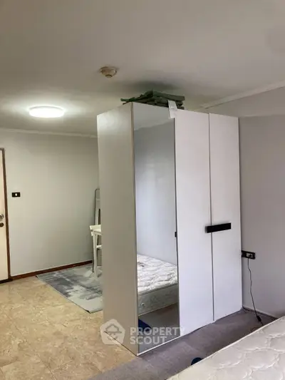 Spacious bedroom with modern wardrobe and natural light